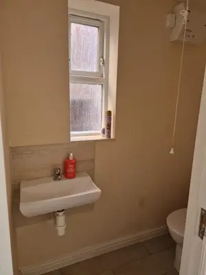 a bathroom with a sink and a window at SK Short Let