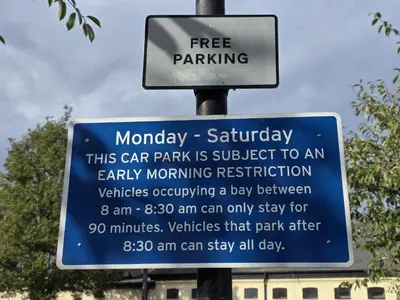 a sign for a car park is subject to an early morning restriction at Stunning One Bed Flat at Dawe Luxury Suites - An Entire Apartment near Ely Cathedral & Train Station - The Perfect Base to Explore Ely, Cambridge, Norfolk & London - 2 Guests Max in Ely