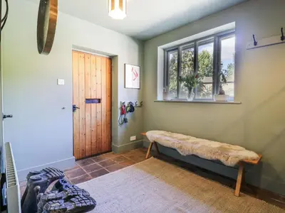a room with a bench and a window at Headland Barn in Maldon