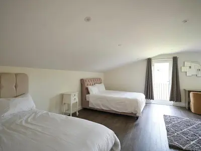 a bedroom with two beds and a window at Whiskey Barns in Birch