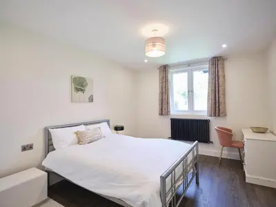 a bedroom with a white bed and a window at Whiskey Barns in Birch