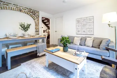 a living room with a couch and a table at Large 6-BDR House in Cambridge in Barnwell Junction Station