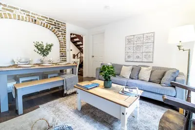a living room with a couch and a table at Large 6-BDR House in Cambridge in Barnwell Junction Station