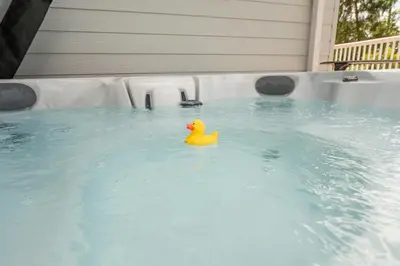 a yellow rubber duck in a pool of water at The Cabin, Ufford in Ufford