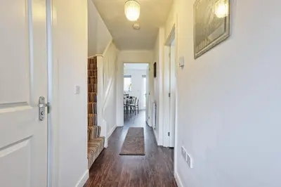 a hallway with white walls and wood floors at Modern 3-Bed 3-Bath Home - Quiet Road - Parking For 2 Cars - LMV Property in Great Burstead