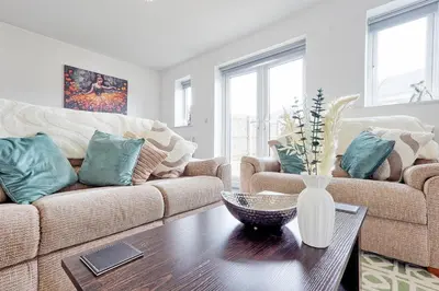 a living room with a couch and a table at Modern 3-Bed 3-Bath Home - Quiet Road - Parking For 2 Cars - LMV Property in Great Burstead