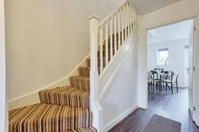 a white staircase in a home with a dining room at Modern 3-Bed 3-Bath Home - Quiet Road - Parking For 2 Cars - LMV Property in Great Burstead