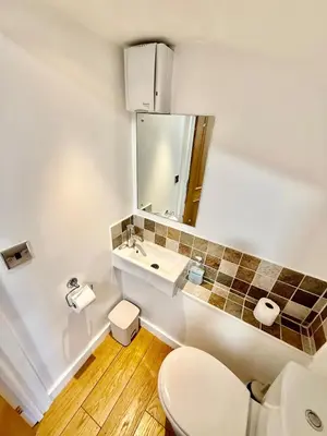 a bathroom with a white toilet and a sink at Beautiful Modern 2 Bed house combined with a vintage feel near Central Cambridge Sleeps 4 in Cambridge