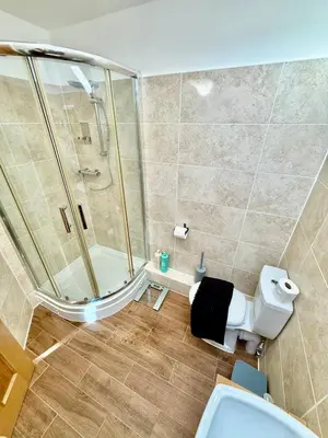 a bathroom with a shower and a toilet at Beautiful Modern 2 Bed house combined with a vintage feel near Central Cambridge Sleeps 4 in Cambridge