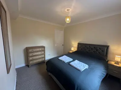 a bedroom with a bed with two towels on it at Ely Stays Flat 2 in Ely