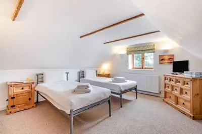 a bedroom with two beds and a television in it at 6 Bed in Three Holes oc-t31855 in Upwell
