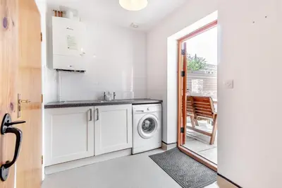 a white kitchen with a washing machine in it at 6 Bed in Three Holes oc-t31855 in Upwell