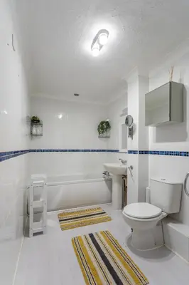 a bathroom with a toilet and a sink and a tub at K Suites - Tollgate Court in Colchester