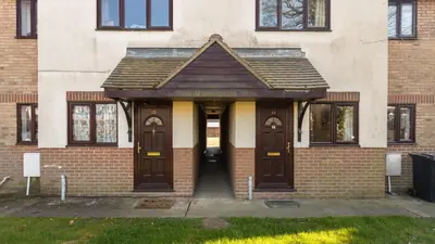 a brick building with two wooden doors in front at K Suites - Tollgate Court in Colchester
