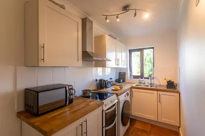 a kitchen with a microwave and a stove top oven at K Suites - Tollgate Court in Colchester