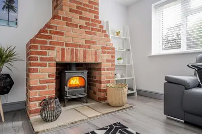 a brick fireplace in a living room at Detached House in Quiet Village - Pets Allowed in Ipswich