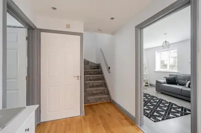 a hallway with a door leading to a living room at Detached House in Quiet Village - Pets Allowed in Ipswich