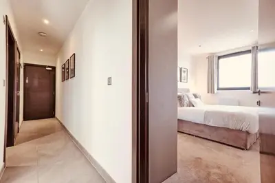 a bedroom with a bed and a window at The Opulent Property Project Penthouse Chelmsford 2 Bed 2 Bath Sleeps 6 Free Parking 2 Kings or 4 singles and Double Sofabed Ideal for long stays, corporates, families, Insurance in Chelmsford