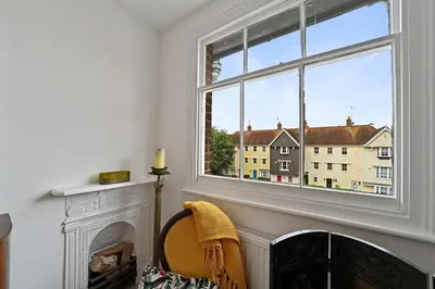 a room with a fireplace and a window at Beautiful Home at the Heart of Colchester Great for Commuters or Professionals in Colchester