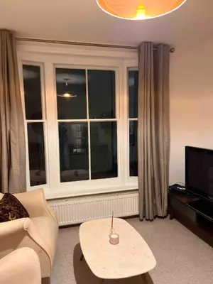 a living room with a couch and a window at Beautiful Home at the Heart of Colchester Great for Commuters or Professionals in Colchester