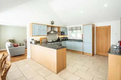 a kitchen with a large island in a room at Woodland Lodge, Aldeburgh in Aldeburgh