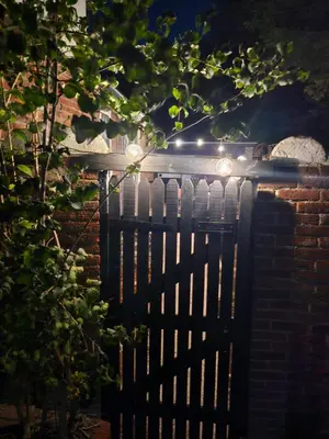 a fence with lights on top of it at Meredith House, Ipswich in Ipswich