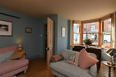 a living room with a couch and a chair at Pilots House Aldeburgh in Aldeburgh