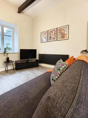 a bedroom with a bed and a flat screen tv at Stylish 2-Bed Home Near A11 in Thetford