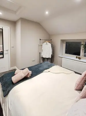 a bedroom with a large white bed and a window at Stylish 2-Bed Home Near A11 in Thetford