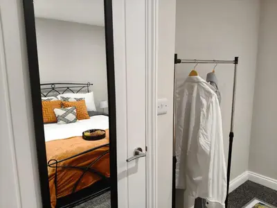a bedroom with a mirror next to a bed at Stylish 2-Bed Home Near A11 in Thetford