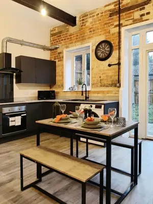a kitchen with a table with glasses on it at Stylish 2-Bed Home Near A11 in Thetford