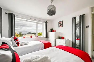 two beds in a room with a window at Modern 3-Bed Maisonette - Epping High Street - Parking - LMV Property in Epping