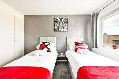 two beds in a room with red and white pillows at Modern 3-Bed Maisonette - Epping High Street - Parking - LMV Property in Epping
