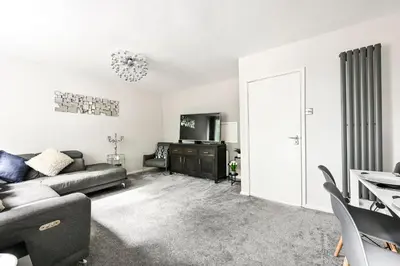a living room with a couch and a tv at Modern 3-Bed Maisonette - Epping High Street - Parking - LMV Property in Epping