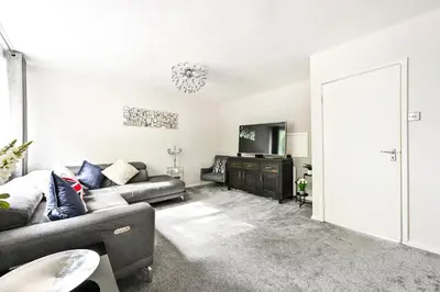 a living room with a couch and a tv at Modern 3-Bed Maisonette - Epping High Street - Parking - LMV Property in Epping