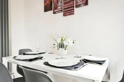 a white table with chairs and a white wall at Modern 3-Bed Maisonette - Epping High Street - Parking - LMV Property in Epping