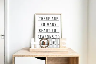 a picture frame on top of a wooden table at Modern 3-Bed Maisonette - Epping High Street - Parking - LMV Property in Epping