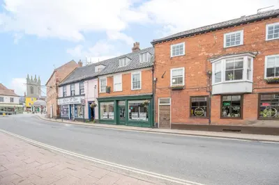 an empty street in a town with brick buildings at The Loft, Bungay in Bungay