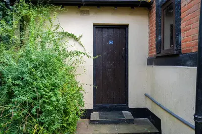 a wooden door on the side of a building at Group Stays 600-Year-Old Barn, sleeps 11 in Great Parndon