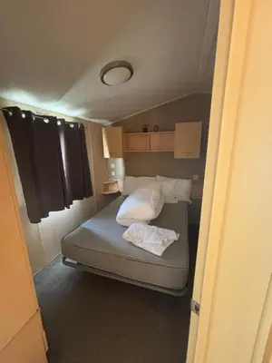 a small bedroom with a bed in a room at Singh&Leite Family L6 in Saint Osyth