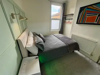 a small bedroom with a bed and a window at Southend city Escape, SS1, High St and beach are steps away in Southend-on-Sea