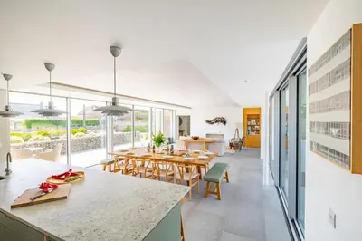 a kitchen and dining room with a table and chairs at Heath House 8 in Thorpeness