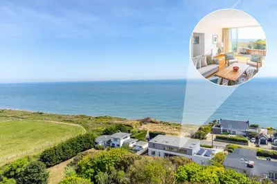 an aerial view of a house next to the ocean at Heath House 8 in Thorpeness
