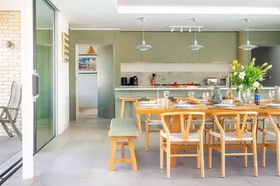 a kitchen and dining room with a wooden table and chairs at Heath House 6 in Thorpeness