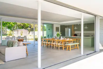 an open kitchen and dining room with sliding glass doors at Heath House 6 in Thorpeness