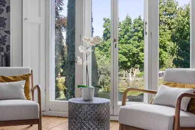 a living room with two chairs and a large window at 6 Bedroom - Luxury - Cinema Room in Hertford