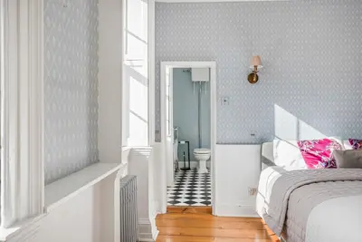 a bedroom with a bed and a bathroom with a toilet at 6 Bedroom - Luxury - Cinema Room in Hertford