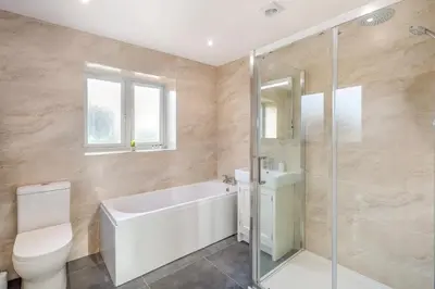 a bathroom with a tub and a toilet and a sink at 5 Bed in Washbrook oc-m33105 in Hintlesham