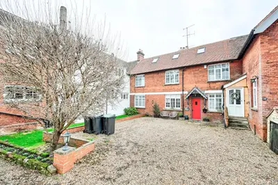 an empty driveway in front of a brick house at Stylish 3-Bed Home Close to Stansted Airport in Stansted Mountfitchet