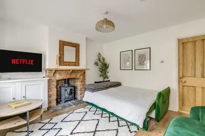 a bedroom with a bed and a fireplace at Riverside Cottage Retreat Hertford Town Sleeps 6 in Hertford